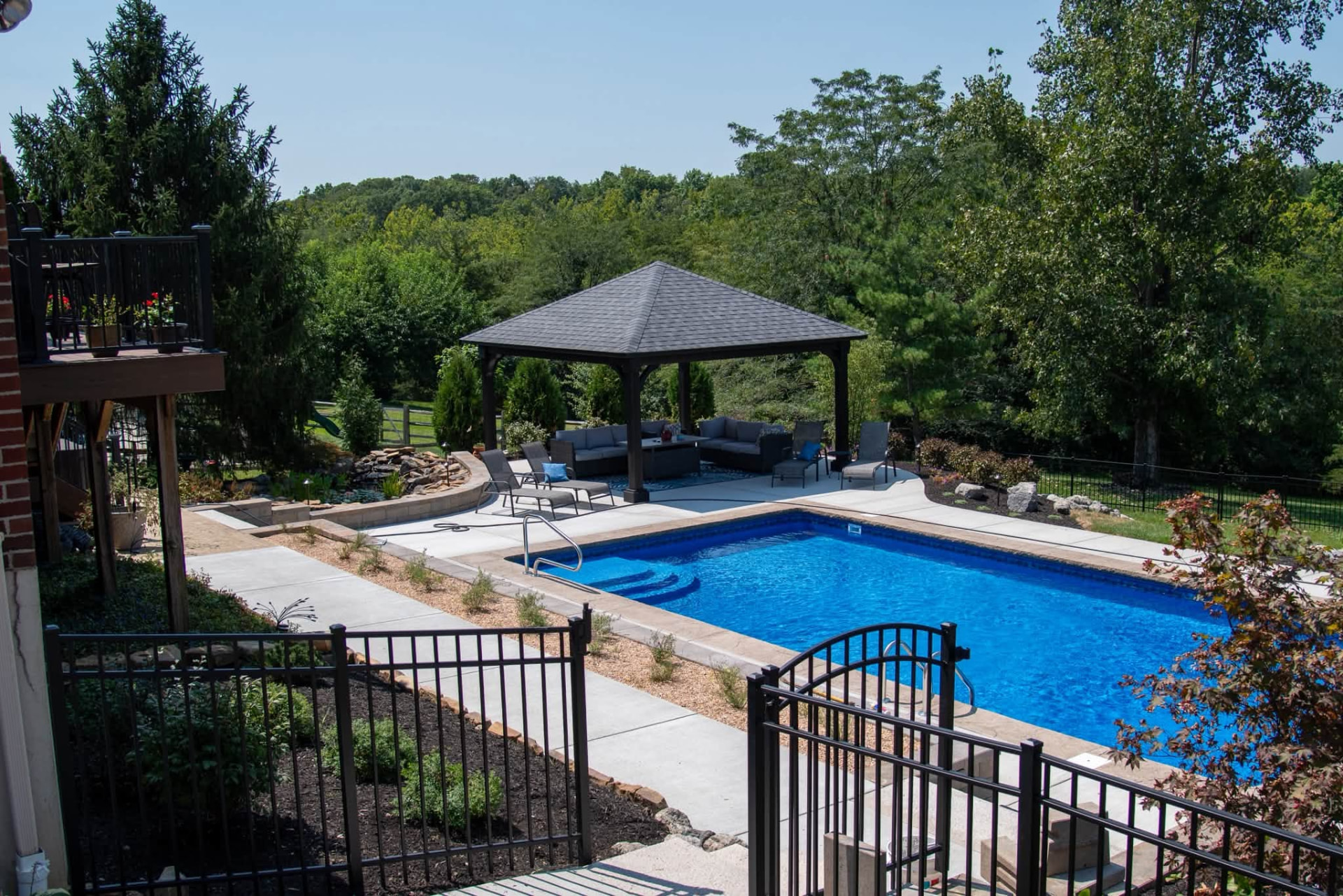Inground pool with paver decking and a timber pavilion built by TJ's Landscaping